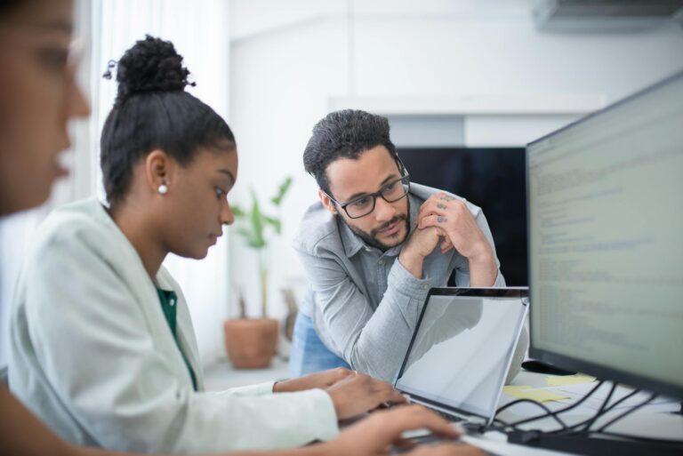 Man in Gray Shirt Looking at the Monitor