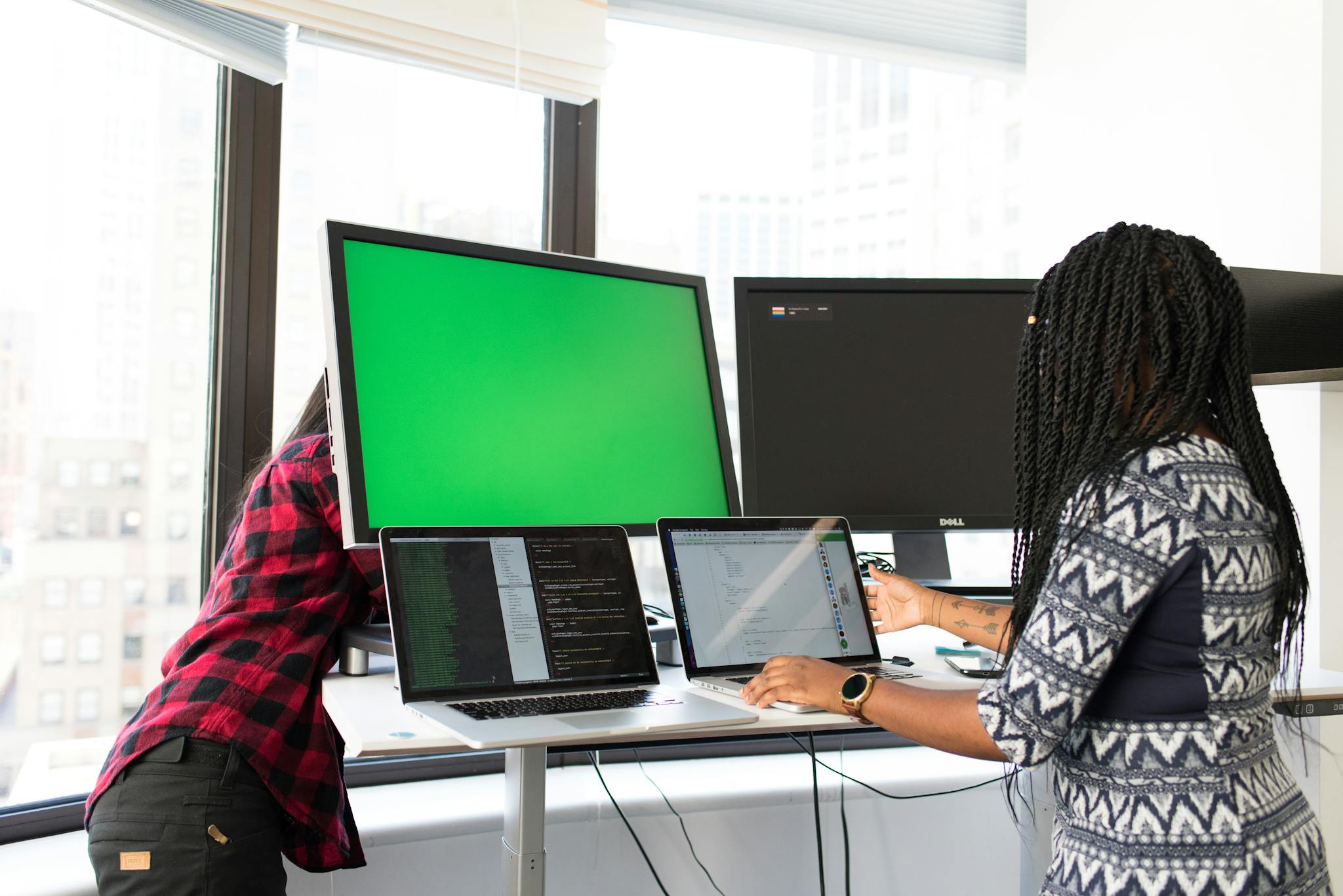Woman Wearing White, Gray, and Black Elbow-sleeved Dress Using Macbook Pro